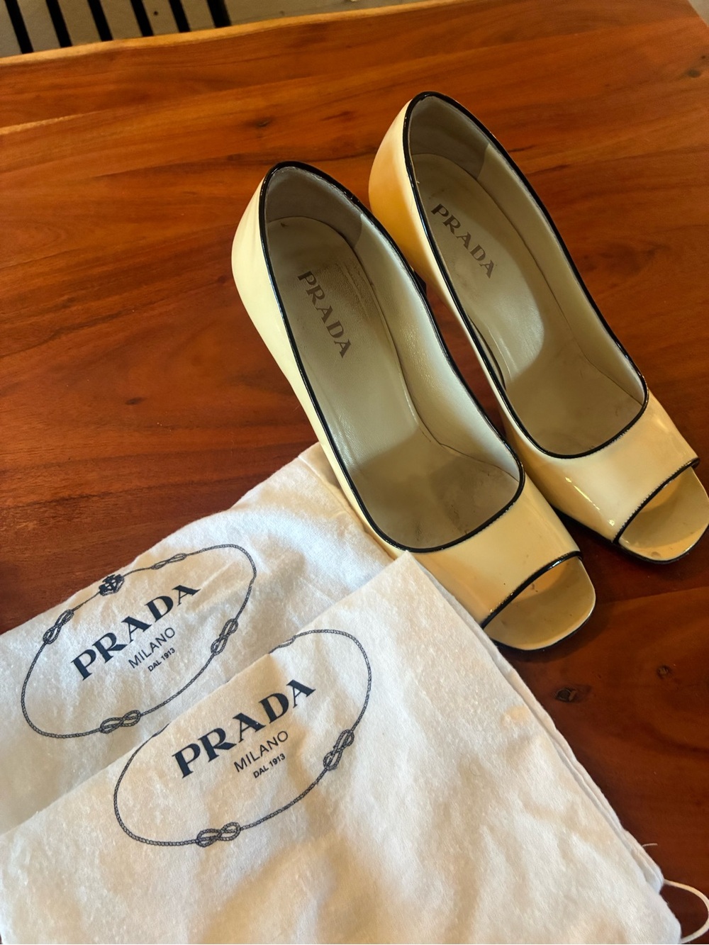 Prada Cream Patent Leather Peep-Toe Pumps with Black Trim